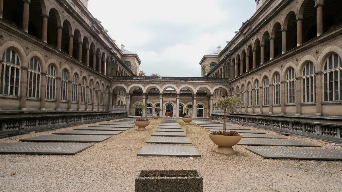 The inner courtyard of the Hôtel-Dieu in Paris, two storeys of arcaded galleries, photograph