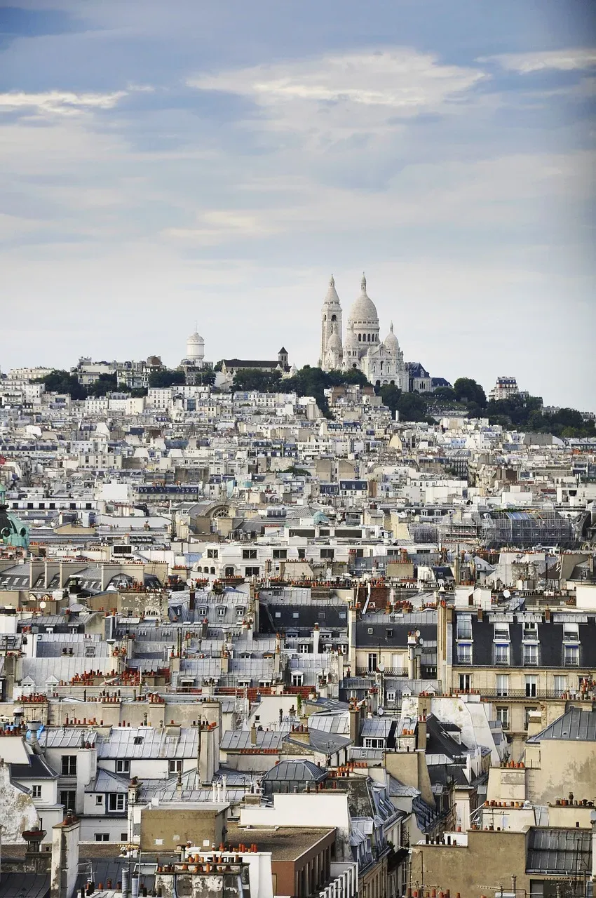 The rooftops of Paris with the Sacré-Cœur basilica on the Montmartre hill in the distance