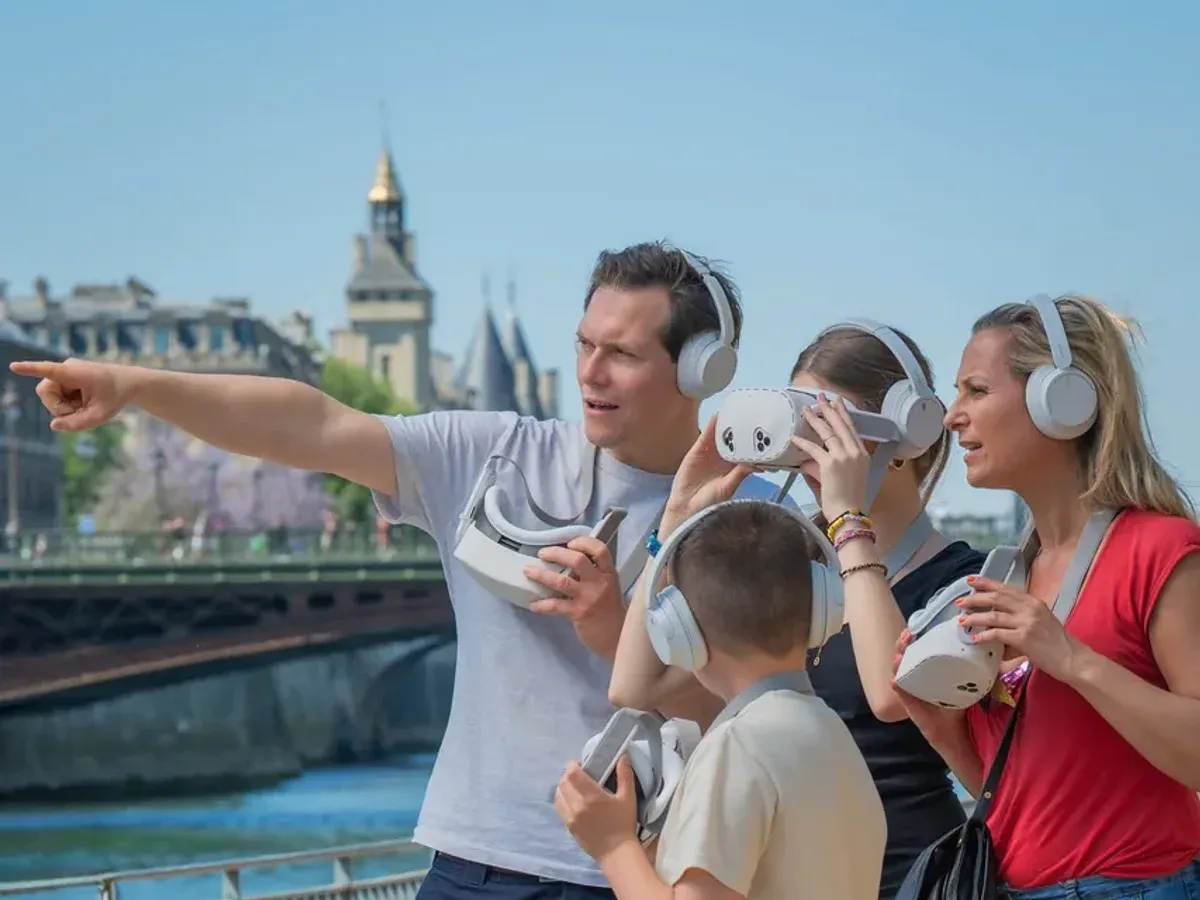 A family on the banks of the Seine, virtual-reality binoculars in hand, the father pointing into the distance