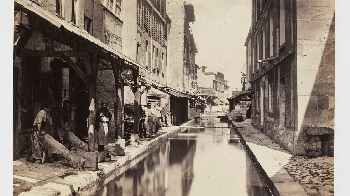 The Bièvre in Paris around 1865, photographed by Charles Marville: a narrow stream between the wooden drying racks of tanneries